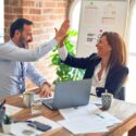 Working professionals giving each other a high five